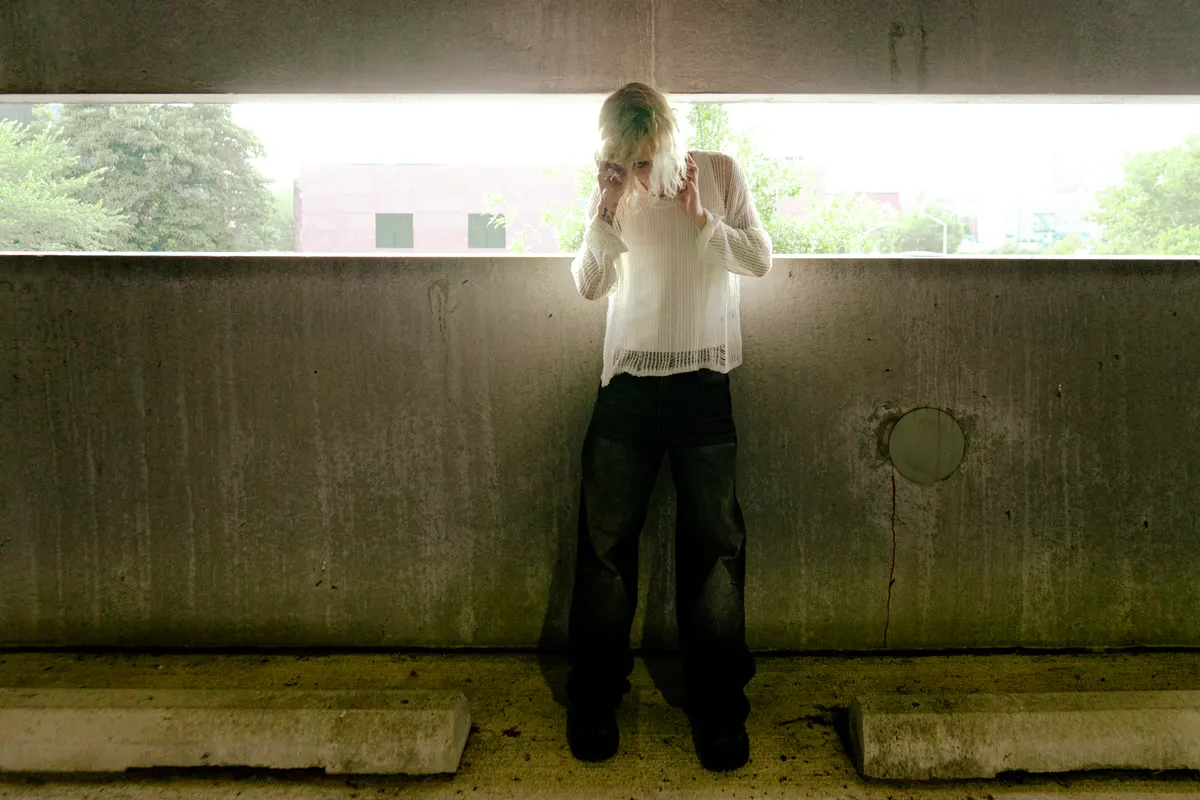 Jordan Andrew standing in a parking garage against bright daylight